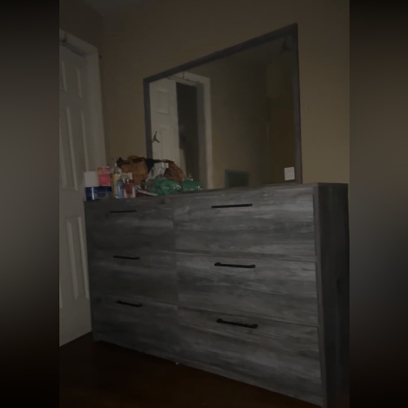 This is a grey dresser that comes with a mirror it’s still in PERFECT condition